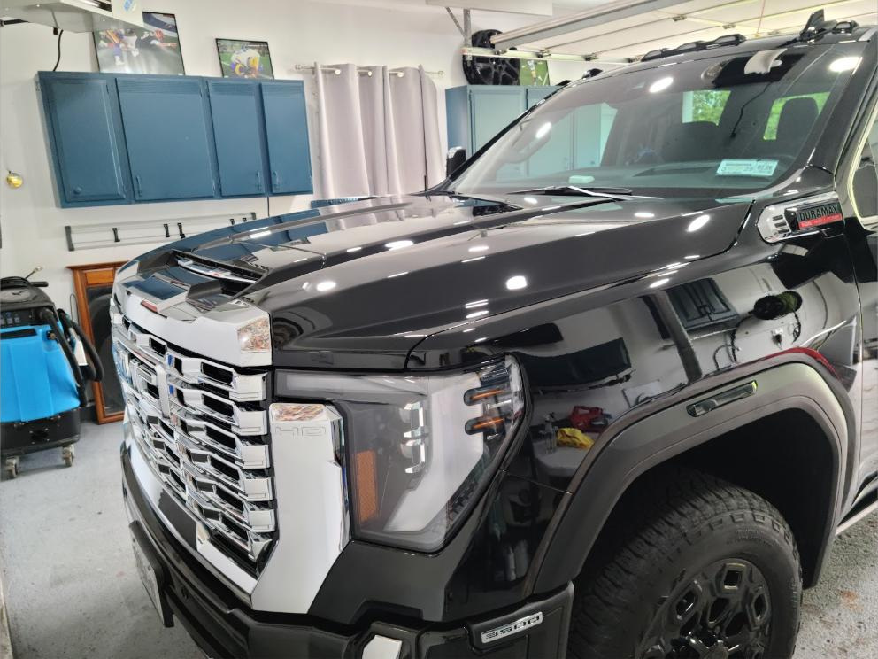 Detailed black pickup with a mirror-gloss finish inside the shop